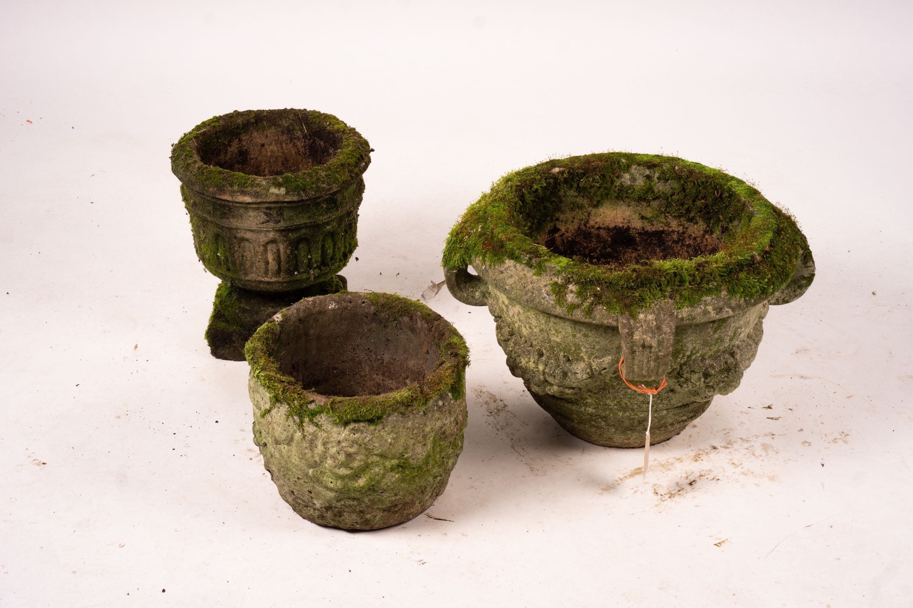 Three weathered reconstituted stone circular garden planters, largest Diam.52cm H.34cm